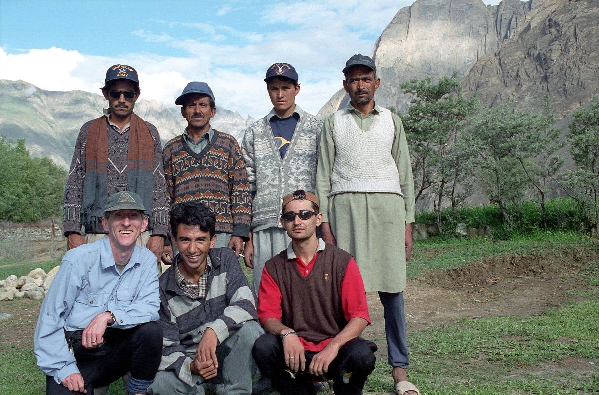 14 Team Photo At Thongol - Jerome Ryan, guide Iqbal, cook Ali, porters Syed, Muhammad Khan, and Muhammad Siddiq, sirdar Ali Naqi We arrive in Thongol and quickly unload the jeep and set up the kitchen tent and my tent where I rest for a few minutes. Ahhh. Iqbal puts together the loads a little bit like a jigsaw puzzle trying to even them out to 25kg each. There are nine loads so Iqbal has to find five more porters. He tells me he's having trouble because the porters want to wait for the mountaineering expedition we met on the flight to Skardu. Here is our team at Thongol: below - Jerome Ryan, guide Iqbal, cook Ali; above - porters Syed, Muhammad Khan, and Muhammad Siddiq, and finally our sirdar Ali Naqi.
